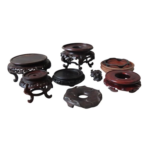 729 - A MIXED GROUP OF SEVEN CHINESE HARDWOOD STANDS, various sizes and styles, with carved and pierced de... 