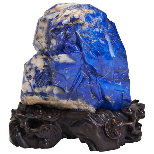 259 - A LAPIS LAZULI BOULDER WITH FITTED HARDWOOD STANDQING DYNASTY, 18TH / 19TH CENTURY清 18/19世纪 青金石山子摆件带... 