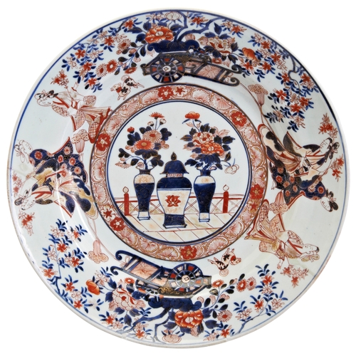 137 - A JAPANESE IMARI CHARGEREDO PERIOD, LATE 17TH / 18TH CENTURYdecorated with flowering urns, carts and... 