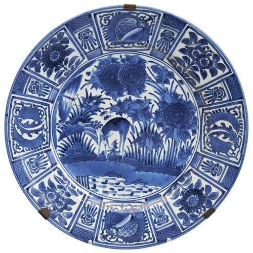 462 - A JAPANESE 'KRAAK' BLUE AND WHITE DISHEDO PERIODdecorated with a scene depicting a deer beside a pon... 