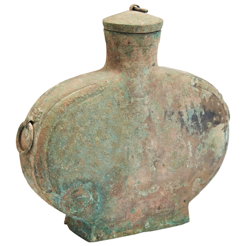 29 - A CAST BRONZE WINE FLASK, BIANHUHAN DYNASTY铜扁壶 汉of flattened ovoid form, the sides applied with two ... 