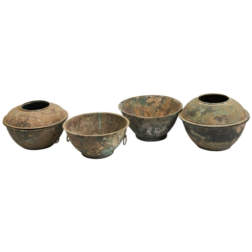 31 - FOUR ARCHAIC BRONZE STEAMERSHAN DYNASTY青铜炉及盖  汉comprising two covered vessels, one with taotie mask ... 