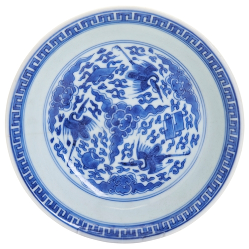 56 - A BLUE AND WHITE 'FLYING-CRANES' DISHKANGXI PERIOD WITH A SIX CHARACTER MARK QI SHI BAO DING ZHI ZHE... 