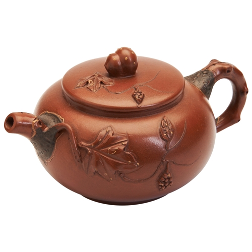 107 - A CHINESE YIXING ZISHA TEAPOT WITH MARK, 20TH CENTURY宜兴紫砂壶 20世纪nicely potted zisha teapot with flowe... 