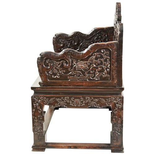 449 - AN IMPRESSIVE CARVED ZITAN THRONE CHAIRMID-QING PERIOD紫檀雕龙椅 清中期the shaped stepped back and sides fin... 