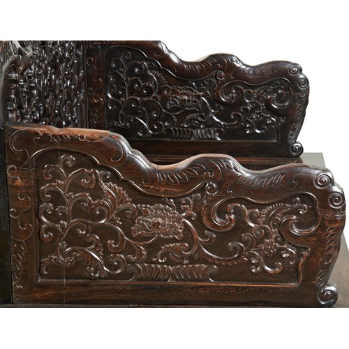 449 - AN IMPRESSIVE CARVED ZITAN THRONE CHAIRMID-QING PERIOD紫檀雕龙椅 清中期the shaped stepped back and sides fin... 