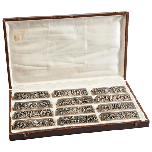 328 - A SET OF TWELVE CHINESE EXPORT SILVER KNIFE RESTSLATE QING DYNASTY银刀具一组  晚清each with figural repouss... 