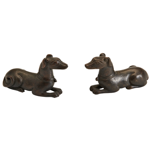 47 - A PAIR OF BRONZE DOGS, SCROLL WEIGHTS,QING DYNASTY 铜卧犬型镇纸  清the recumbent animal seated with its leg... 