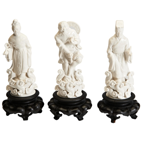 113 - THREE BLANC DE CHINE DAOIST IMMORTALS ON WOOD STANDS, EARLY 20TH CENTURY德化 道教人物像 20世纪a group of Blan... 