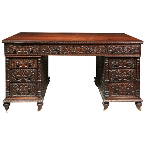 484 - A GOOD ANGLO-INDIAN CARVED PADOUK PEDESTAL DESK19TH CENTURY the sides finely carved with an all desi... 