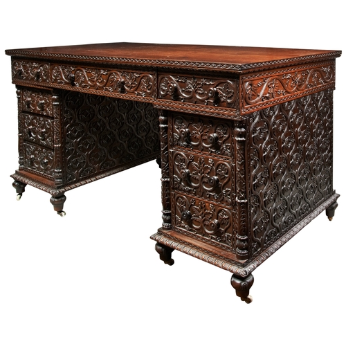 484 - A GOOD ANGLO-INDIAN CARVED PADOUK PEDESTAL DESK19TH CENTURY the sides finely carved with an all desi... 