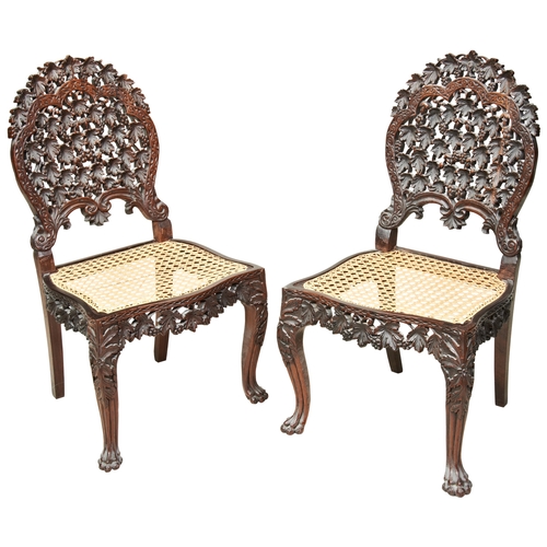 485 - A PAIR OF ANGLO-INDIAN CARVED HARDWOOD SIDE CHAIRS19TH CENTURYthe pierced shaped back carved through... 