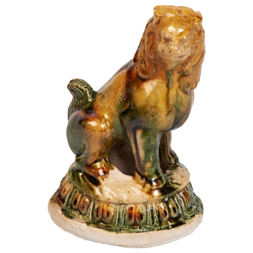 151 - A SANCAI GLAZED LION FORM INCENSE BURNERMING OR LATER三彩狮子 明或以后a lion seated on the louts flower, wit... 