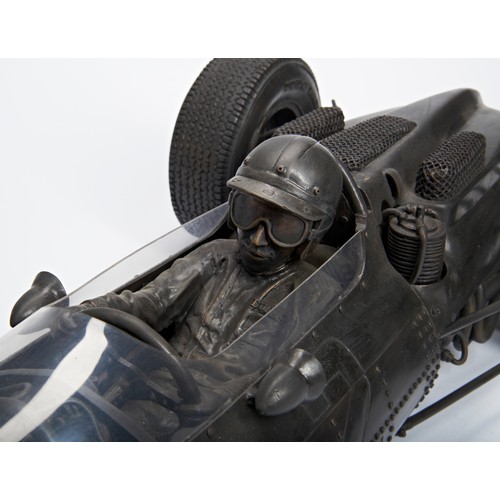 A BRONZE SCULPTURE BY RENZO JARNO VANDI REPRESENTING 1964 F1 WORLD CHAMPION JOHN SURTEES AT THE WHEEL OF HIS FERRARI 158