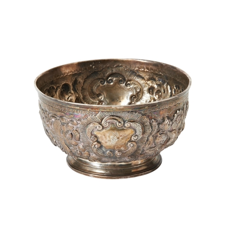 20 - GEORGIAN IRISH EMBOSSED BOWL DUBLIN C.1780 Chased all over with fruit and scrolls.16 cm. dia.404 g.... 