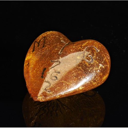 38 - A CHARLES II CARVED AMBER HEART C.1672. The transparent amber is inscribed on one side with the Cyph... 