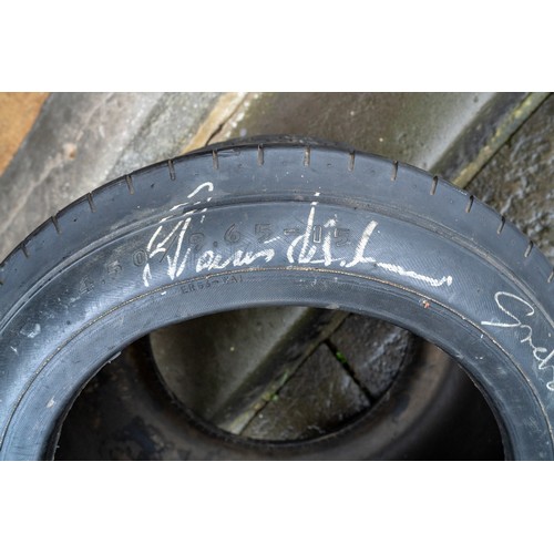 41 - GOOD-YEAR RACING TYRE, SIGNED BY JIM CLARK, GRAHAM HILL AND JACK BRABHAMThree World Motor Racing Cha... 