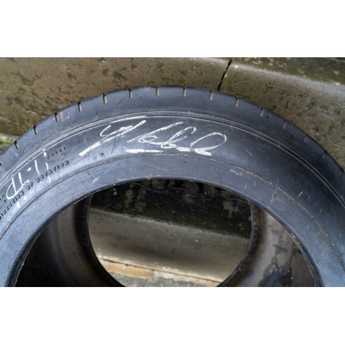 41 - GOOD-YEAR RACING TYRE, SIGNED BY JIM CLARK, GRAHAM HILL AND JACK BRABHAMThree World Motor Racing Cha... 