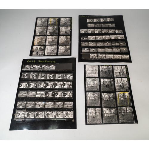 62 - 11 LARGE FORMAT PHOTO CONTACT SHEETS DEPICTING JOHN SURTEESAt home with his dogs playing in the snow... 