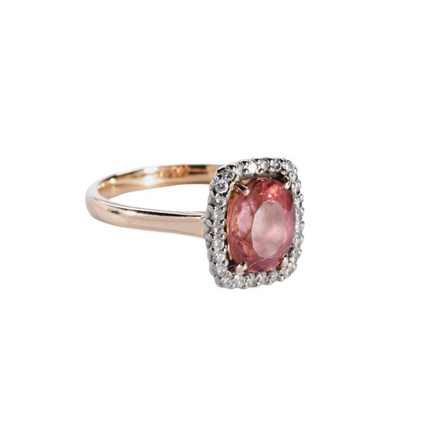 308 - A MORGANITE AND DIAMOND RING, the oval mixed-cut morganite, four claw set withtin a bezel of brillia... 