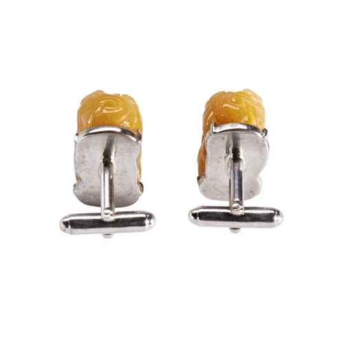 255 - A PAIR OF YELLOW JADE STONES CARVED AS BUDDHISTIC LIONS mounted in 925 silver cuff links, approx 2cm... 