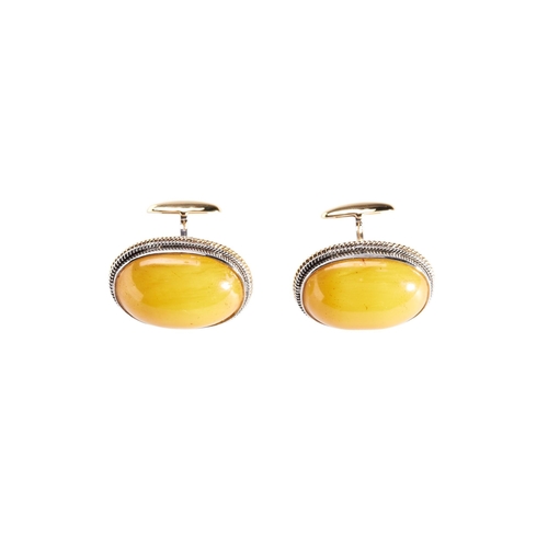 263 - PAIR OF BUDDHIST AMBER CABOUCHON CUFF LINKS mounted in 18k white and yellow gold, approx 3cm, total ... 