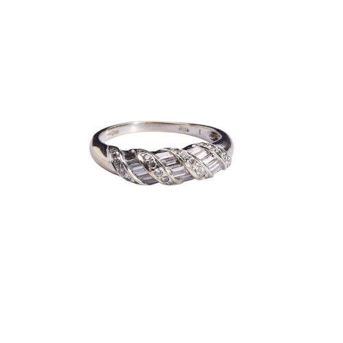 329 - A DIAMOND DRESS RINGThe upper domed section set with alternate rows of brilliant and baguette-cut di... 