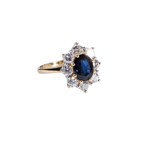 337 - A SAPPHIRE AND DIAMOND CLUSTER RINGthe oval mixed-cut sapphire eight claw set above a bezel of eight... 