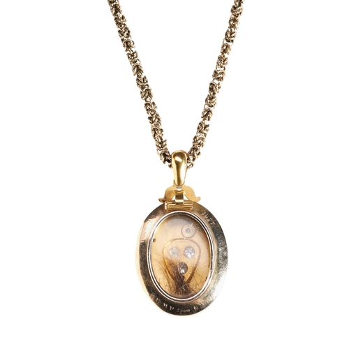 225 - VICTORIAN GOLD AND DIAMOND LOCKET, CIRCA 1880the oval hinged locket set to the front with three old ... 