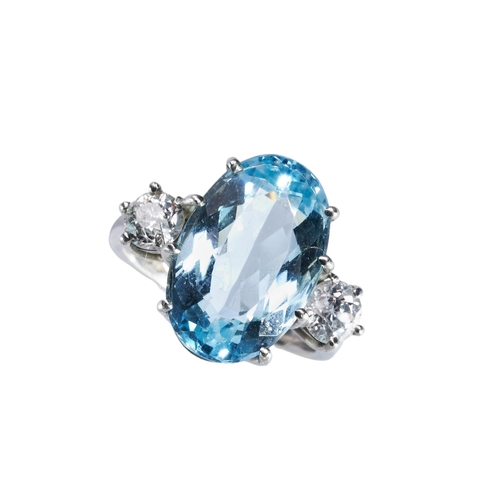 352 - AN AQUAMARINE AND DIAMOND RINGthe oval mixed-cut aquamarine eight claw set above a pierced gallery, ... 