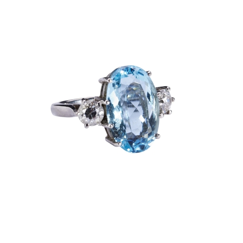 352 - AN AQUAMARINE AND DIAMOND RINGthe oval mixed-cut aquamarine eight claw set above a pierced gallery, ... 