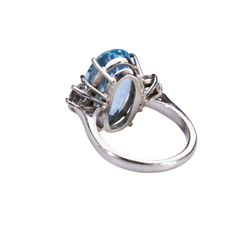 352 - AN AQUAMARINE AND DIAMOND RINGthe oval mixed-cut aquamarine eight claw set above a pierced gallery, ... 