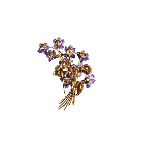 306 - AN AMETHYST AND GOLD FLORAL SPRAY BROOCH, CIRCA 1960the elaborate floral spray set with nine amethys... 