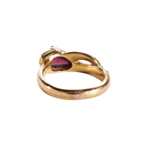 212 - AFTER THE ANTIQUE; A GOLD AND GARNET SNAKE RING, CIRCA 1850the snake's head set with a cabochon-cut ... 