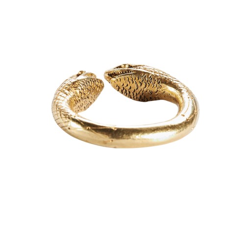 213 - AFTER THE ANTIQUE, A GOLD SNAKE RINGthe torque style ring with two snake terminals, with textured sh... 