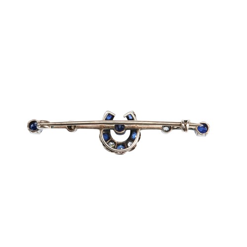 345 - A SAPPHIRE AND DIAMOND BROOCH, CIRCA 1880the knife edge bar set with a sapphire and diamond horsesho... 