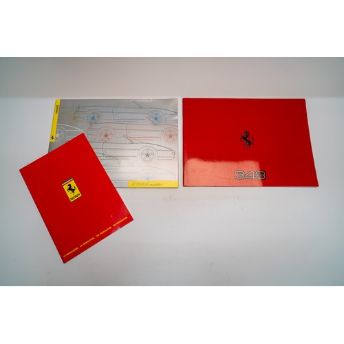 141 - A COLLECTION OF FERRARI MERCHANDISE - PIN BADGES, STICKERS, BROCHURESBrochures covering the 328, 348... 