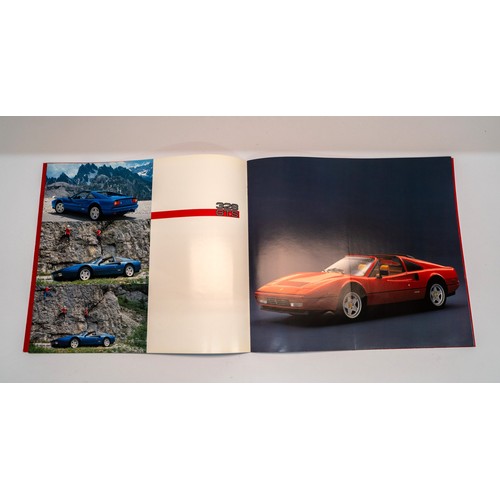 141 - A COLLECTION OF FERRARI MERCHANDISE - PIN BADGES, STICKERS, BROCHURESBrochures covering the 328, 348... 