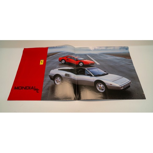 141 - A COLLECTION OF FERRARI MERCHANDISE - PIN BADGES, STICKERS, BROCHURESBrochures covering the 328, 348... 