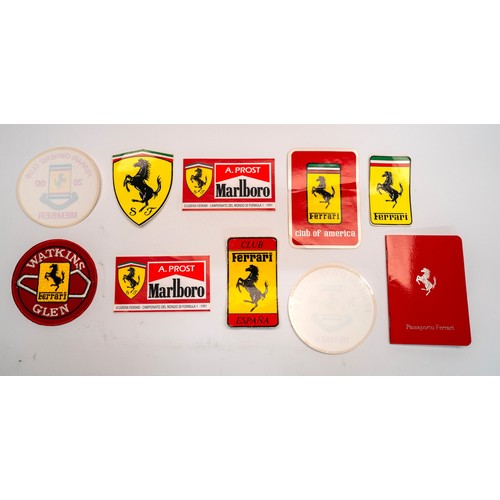 141 - A COLLECTION OF FERRARI MERCHANDISE - PIN BADGES, STICKERS, BROCHURESBrochures covering the 328, 348... 