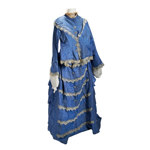 411 - A MID NINETEENTH CENTURY BLUE AND SILK LADY'S DRESS;comprising two pieces, trimmed with lace and cut... 