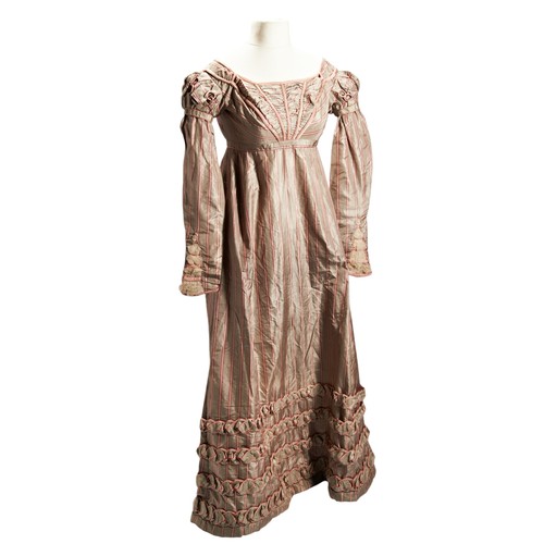 412 - A REGENCY SILK DRESS;the pinkish red and grey striped silk with lace insert with quilted detailmeasu... 