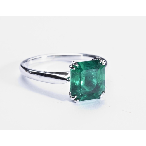 365 - COLUMBIAN TREATED EMERALD RINGthe step-cut cut cornered treated emerald four double claw set, betwee... 