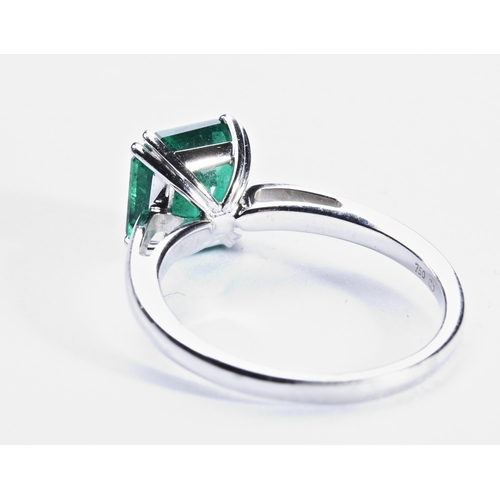 365 - COLUMBIAN TREATED EMERALD RINGthe step-cut cut cornered treated emerald four double claw set, betwee... 