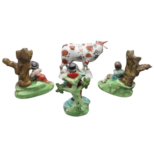 198 - A PAIR OF EARLY 19TH CENTURY FIGURAL SPILL HOLDERS AND A DELFT POLYCHROME COW MODEL, together with a... 