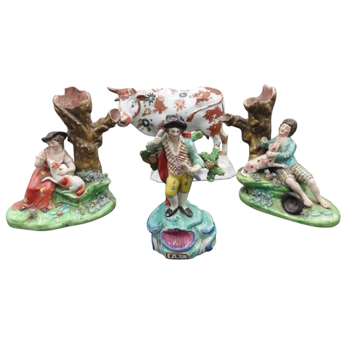 198 - A PAIR OF EARLY 19TH CENTURY FIGURAL SPILL HOLDERS AND A DELFT POLYCHROME COW MODEL, together with a... 