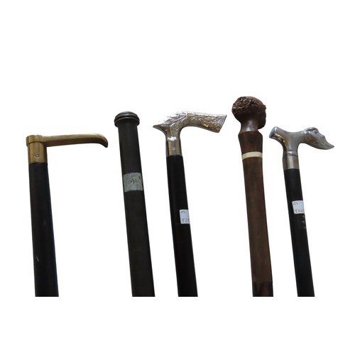 253 - A MIXED GROUP OF FOUR WALKING CANES, including a carved hardwood bone inset cane, a compass inset ca... 