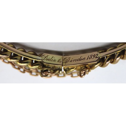 356 - A VICTORIAN GOLD BRACELET, the hinged curb link bracelet engraved 'Didie to Dindie, 1892, on the cla... 