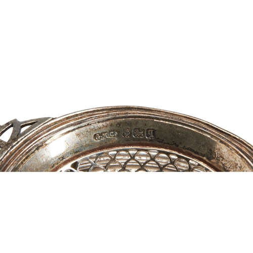 329 - A VINTAGE SILVER TEA STRAINER, the strainer sat upon a galleried circular stand, on ball feet, marke... 