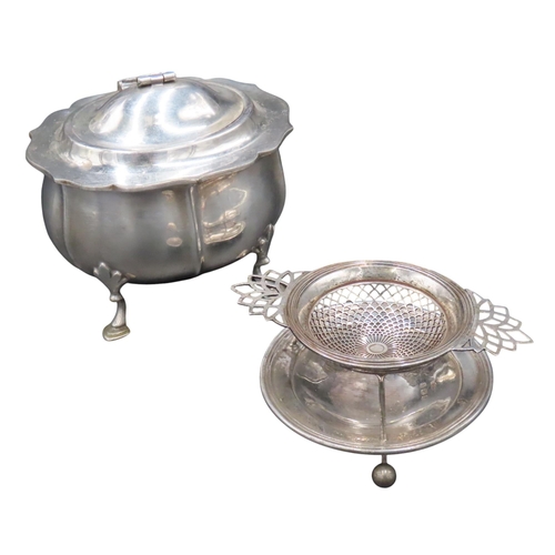 329 - A VINTAGE SILVER TEA STRAINER, the strainer sat upon a galleried circular stand, on ball feet, marke... 